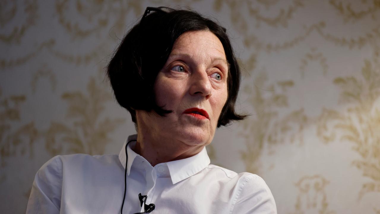 Die Schriftstellerin Herta Müller, vor einer Tapetenwand nach rechts blickend